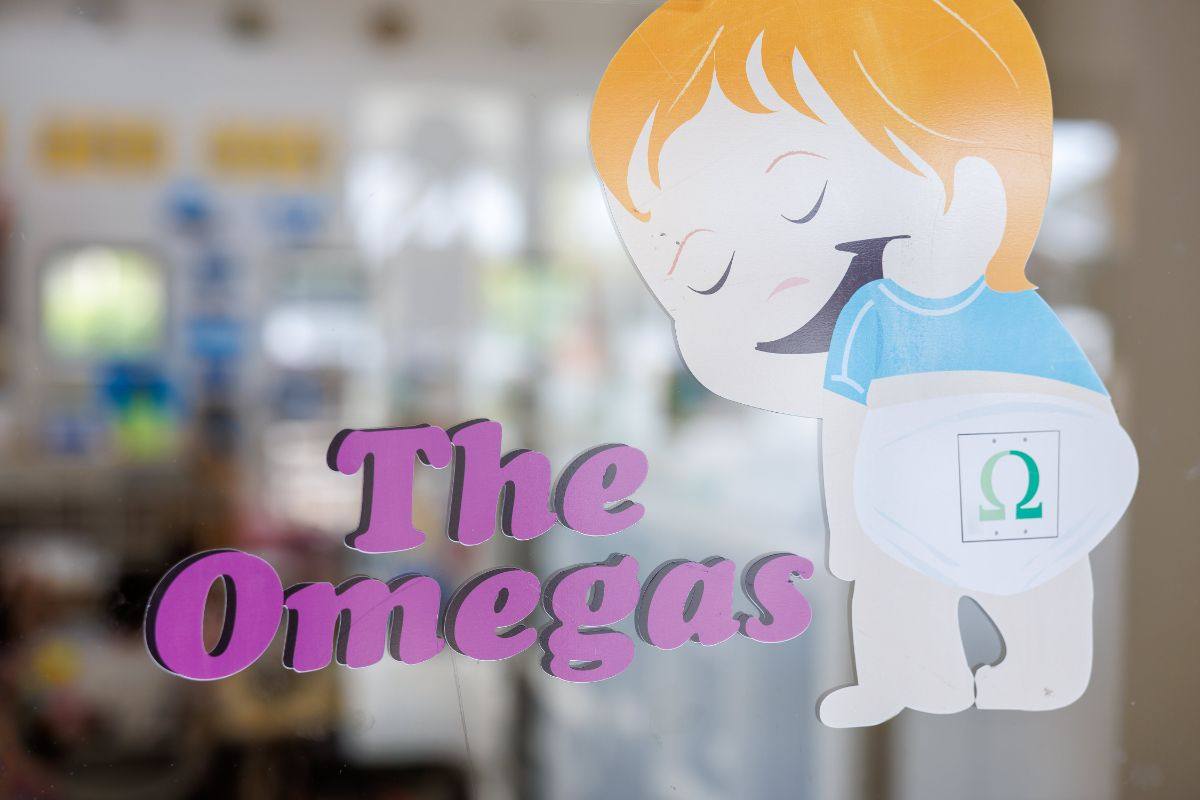 The Omegas room sign